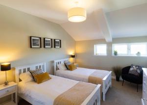 a bedroom with two beds and a window at Heads Of Ayr Holiday Park in Ayr