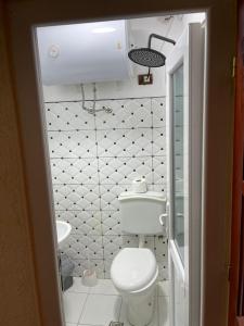 a small bathroom with a toilet and a sink at Hotel bar restaurant Gjoçaj in Kolgecaj