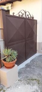 a black gate with potted plants in front of it at La Forosetta Guest House in Norcia