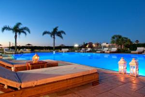 a large swimming pool with lights and a resort at Socrates Hotel Malia Beach in Malia