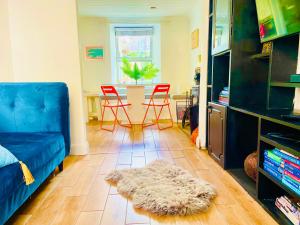 a living room with a blue couch and a table at 4 Market Street in Bantry