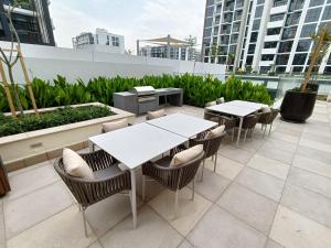 a patio with tables and chairs on a roof at Luxury Staycation Studio in Royal Neighbourhood in Dubai