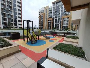 a playground on the roof of a building with tall buildings at Luxury Staycation Studio in Royal Neighbourhood in Dubai