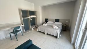 a bedroom with a bed with towels on it at Il Narciso Residence in Tropea