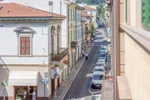 eine Stadtstraße mit parkenden Autos und Gebäuden in der Unterkunft Tra Storia, Benessere e Natura in Montecatini Terme