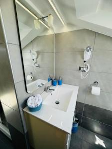 a bathroom with a sink and a mirror at Sky Loft in Alba +11 photos