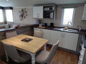 科克茅斯的住宿－Green Dream，一个带木桌和椅子的小厨房