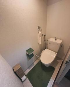 une salle de bain avec des toilettes blanches dans une chambre dans l'établissement Monster lodge 札幌, à Sapporo