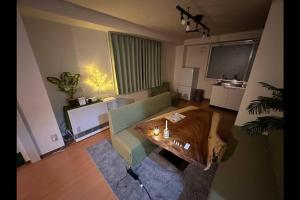 a living room with a couch and a table at Monster lodge 札幌 in Sapporo