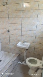 a bathroom with a toilet and a sink at JOLLY'S PARK GUEST HOUSE in Roodepoort