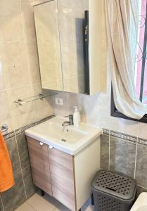 a bathroom with a sink and a mirror at Comfortable apartment in the heart of Las Americas in Playa de las Americas