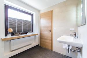 a bathroom with a sink and a window at Südtiroler Stuben in Essen +9 photos