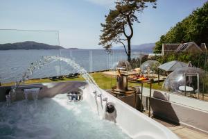 a bath tub with water spraying out of it at Ardrhu House Fort William - Serviced Luxury Scots Baronial Country House in Fort William