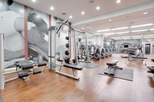 a gym with several treadmills and cardio machines at Condo Near to Metro Station at Crystal city in Arlington