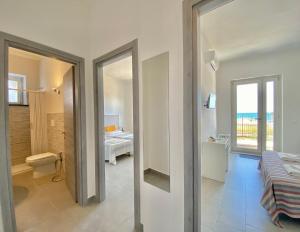 a room with a bathroom with a toilet and a bedroom at Amoenus Bed & Breakfast in family in Soverato Marina