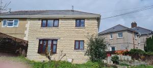 a large brick house with windows at Hillside in Llanelli