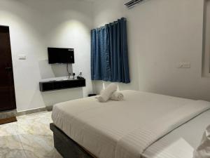een slaapkamer met een bed en een wastafel bij Le Tamara Luxury in Auroville