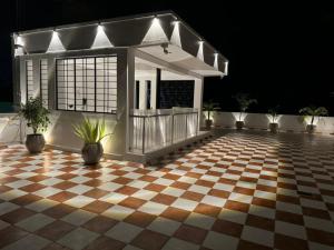 a house with a checkered floor at night at Le Tamara Luxury in Auroville