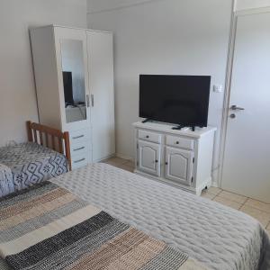 a bedroom with a flat screen tv on a dresser at Apartment Matic Duboka in Duboka