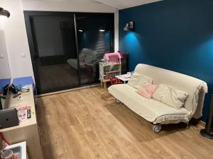 a living room with a white couch and a blue wall at Villa privée piscine en Provence in Rougiers +19 photos