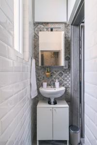 uma casa de banho branca com um lavatório e um espelho em Heroes' Square Stay em Budapeste