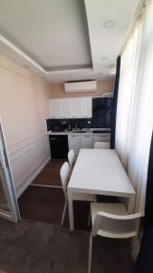 a small kitchen with a white table and chairs at Ozef Suites in Istanbul