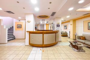 a lobby with a bar in the middle of a room at Faros II in Piraeus