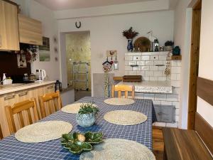 a kitchen with a table with four chairs and a kitchen with a counter at Apartament Hajstra z ogrodem in Grodzisk