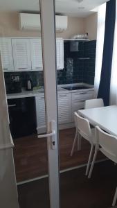 a kitchen with a table and chairs and a kitchen with white cabinets at Ozef Suites in Istanbul