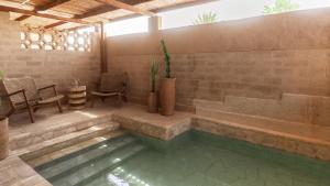 a pool in a patio with a table and chairs at MOA Living in Ẕofar