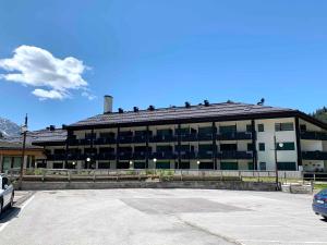a large building with a parking lot in front of it at Monolocale Nardis 111 in Madonna di Campiglio