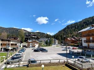 a parking lot with cars parked in a parking lot at Monolocale Nardis 111 in Madonna di Campiglio
