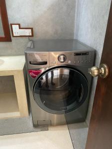 a microwave oven sitting in a kitchen next to a door at Villa La more in Unawatuna