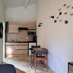 a kitchen with a small table and a kitchen with a counter at songes d été 6 in Bonifacio