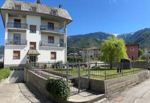 a white building with a fence in front of it at CASA STAVELLO in Sernio