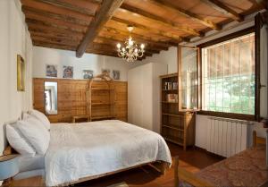 a bedroom with a bed and a chandelier at Villa Buonasera Agriturismo in Greve in Chianti