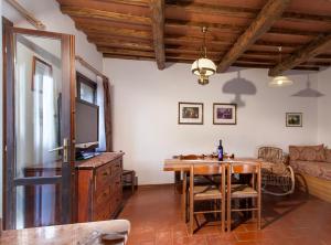 a living room with a table and a television at Villa Buonasera Agriturismo in Greve in Chianti