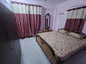 Postelja oz. postelje v sobi nastanitve Satwik Homestay