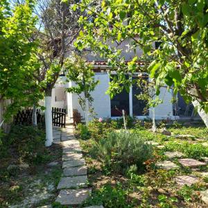a garden in front of a house at Saint Anna Country House. in Agia Anna