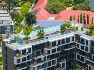 an aerial view of a building with a swimming pool at Skypark Laguna Rooftop Pool Apartment near Bang Tao Beach in Bang Tao Beach