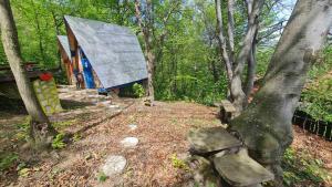 a small house in the woods with two benches at Cabin 3 Hill Station in Sarajevo +5 photos