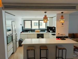 a kitchen with a large white island in a room at Bel Appartement en face de la mer in Dakar