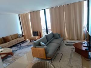 a living room with a couch and a table at Bel Appartement en face de la mer in Dakar