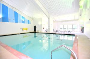 a large swimming pool in a building at Treetop Cabin -- Pool Access - Fireplace - Grill - Screen Porch - Deck - Wifi - Golf Nearby in Hedgesville