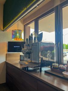 a kitchen counter with a coffee machine on top of it at Boutique Hotel & Event Center in Budapest