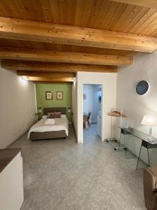 a bedroom with a bed and a wooden ceiling at Tanto di Cappello Home in Palermo