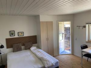 a bedroom with a bed and a sliding glass door at Marielyst Beach and downtown rooms in Bøtø By