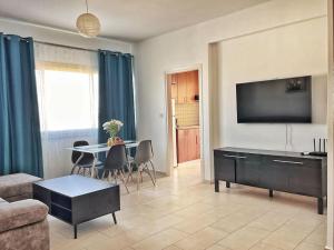 a living room with a couch and a table at TEO Apartment in Paphos