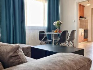 a living room with a couch and a table with chairs at TEO Apartment in Paphos