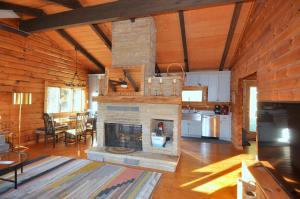 a living room with a stone fireplace in a cabin at River View Cabin - Mountain Views in Morton Grove